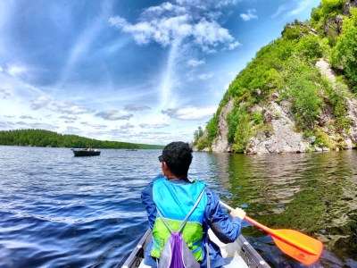 a person standing next to a body of water