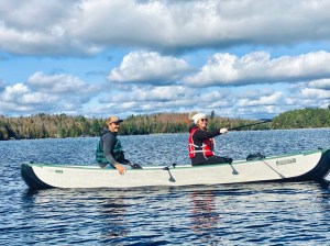 a group of people rowing a boat in the water