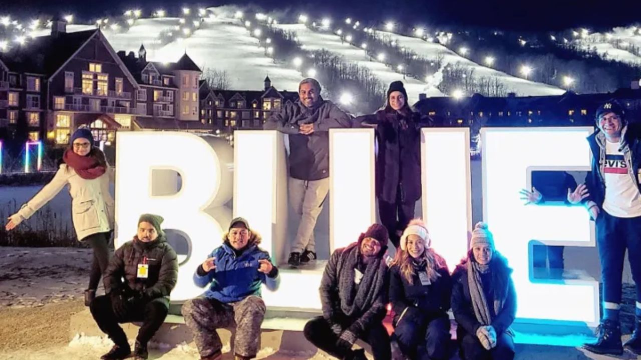 Group of friends posing in front of large illuminated “BLUE” during the Blue Mountains hike