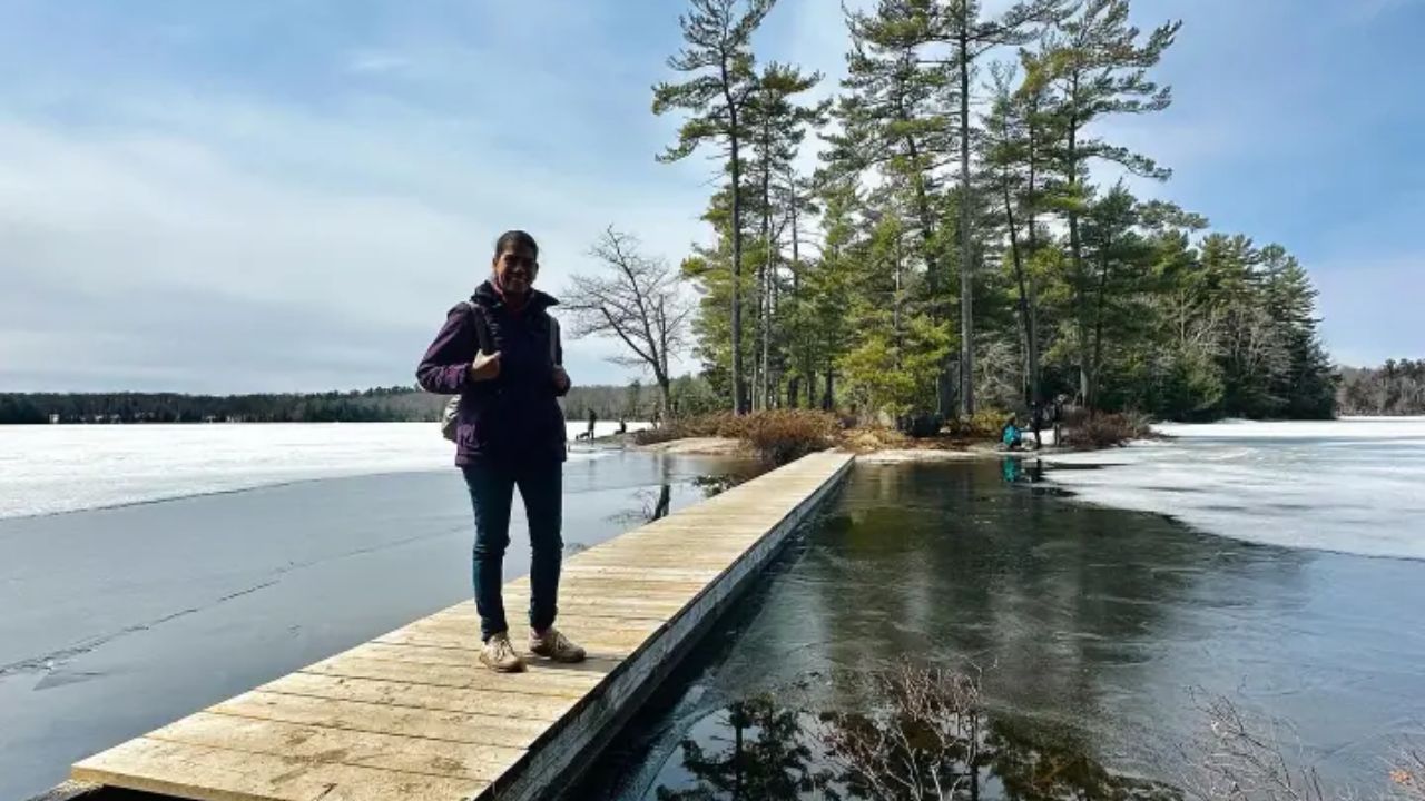 A person standing on a wooden dock at Muskoka