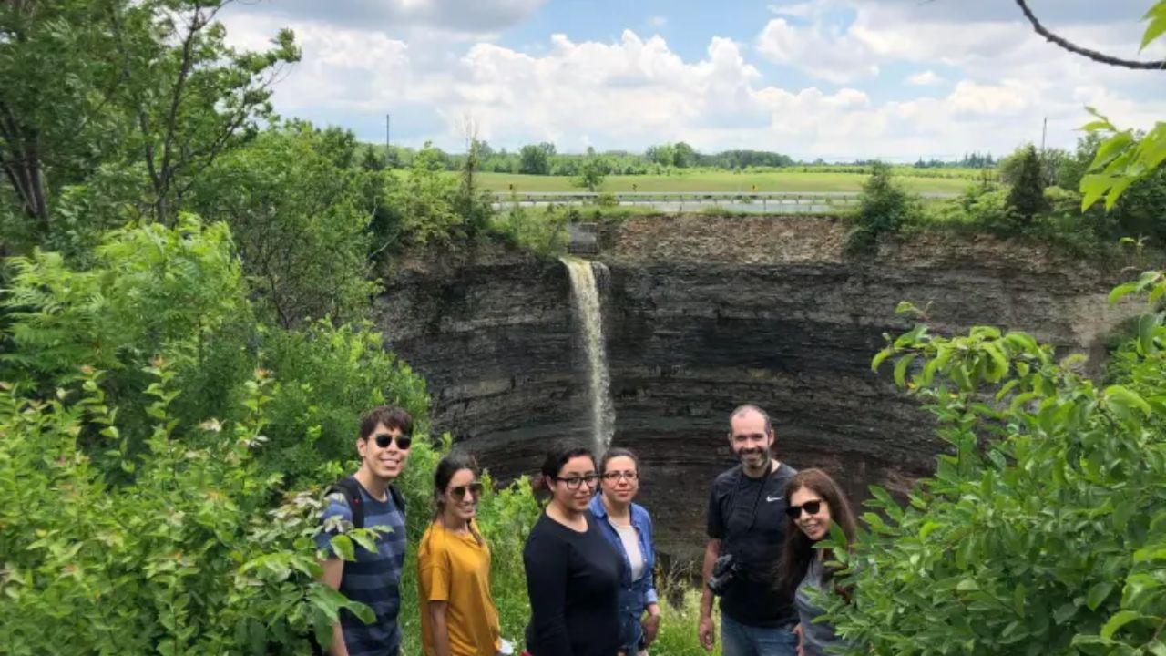 A group of people standing near Devil’s Punchbowl Falls