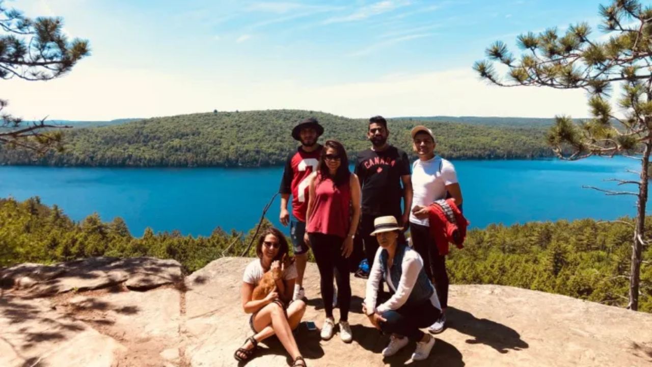 Group of hikers posing on a rocky viewpoint. 