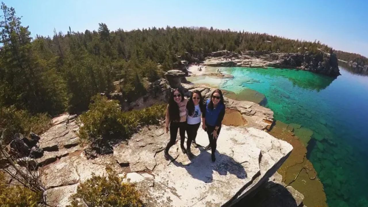 Scenic Tobermory viewpoint with crystal clear water and rocky shoreline
