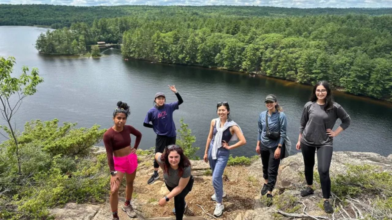 Group hiking in Tobermory with scenic lake and forest views