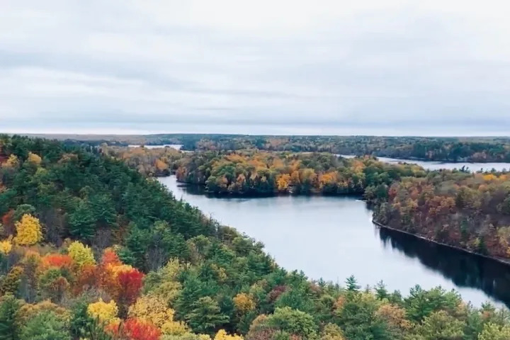 Scenic autumn lake surrounded by colorful fall foliage in the Rock Dunder wilderness