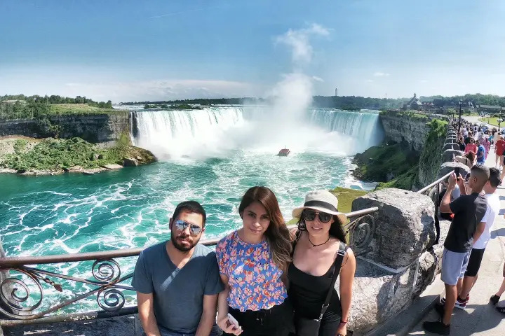 Tourists posing at a Niagara Falls lookout point