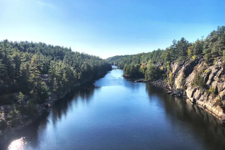 Scenic river flowing through rocky cliffs along the French River.